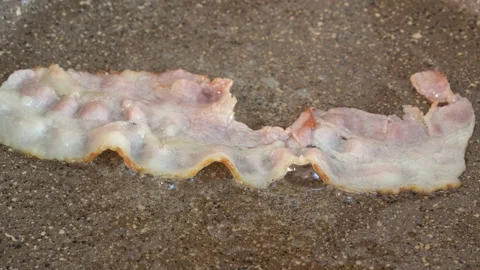 Close-up view of bacon slices in frying pan. Stock-Footage 178533835