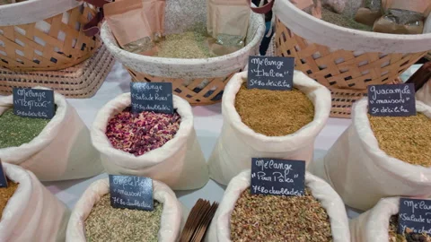 Close view of bags of herb and spice blends with handwritten French labels at a Stock Footage 344824380
