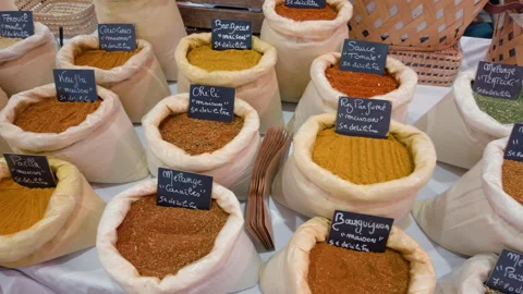 Close view of bags of herb and spice blends with handwritten French labels at a Stock Footage 344824585