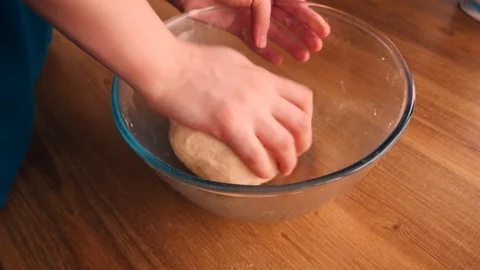 Close up view of baker kneading dough in flour on plate.Manufacturing process, w Stock-Footage 125510336