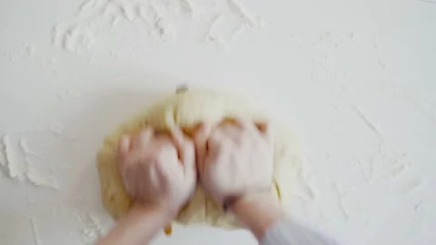 Close up view of baker kneading dough in flour on table. Manufacturing process Stock Footage 135365343