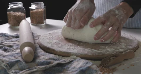 Close up view of baker kneading dough in flour on table. Stock Footage 138562432