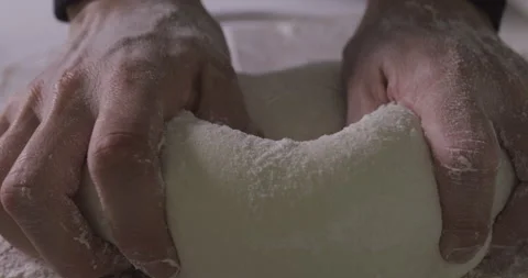 Close up view of baker kneading dough in flour on table. Stock Footage 138564991