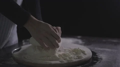 Close up view of baker kneading dough in flour on table. Stock Footage 138566133
