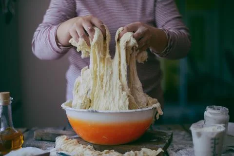 Close up view of baker kneading dough. Homemade bread. Hands preparing bread  Stock Photos