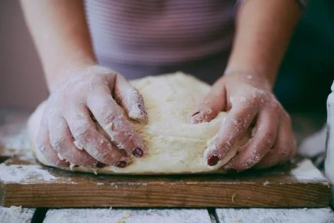 Close up view of baker kneading dough. Homemade bread. Hands preparing bread  Stock Photos