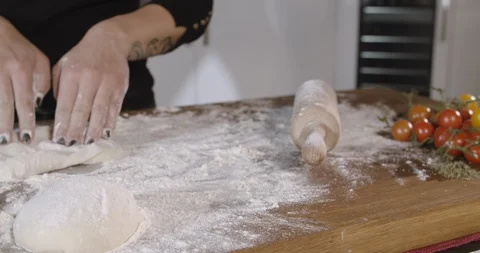 Close up view of baker's hands kneading the dough on the table. Stock Footage 124876598