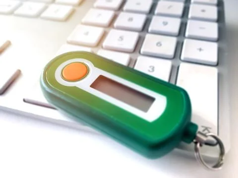 Close-up view of a bank code generator on a computer keyboard 스톡 사진