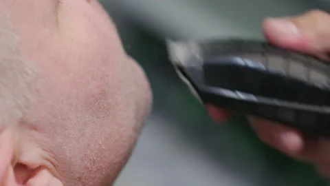 Close-up view of a barber shaving face with electric razor Stock Footage 222862294