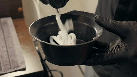 Close up view of barber squeezing foam into bowl Stock Footage 125132191