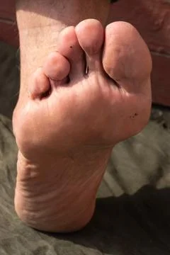 Close-up view of a bare human foot showing detailed skin texture and toes, po Stock Photos