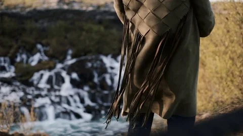 Close-up view of Barnafoss waterfall in Iceland and female back. Fringe from Stock Footage