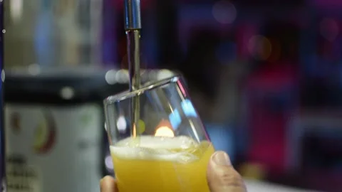 Close-up view of a bartender hand pouring a beer into glass from tap in a bar Stock Footage 142593846