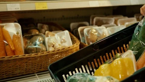 Close up view of basket in the vegetable department where woman putting the Stock Footage 76976245