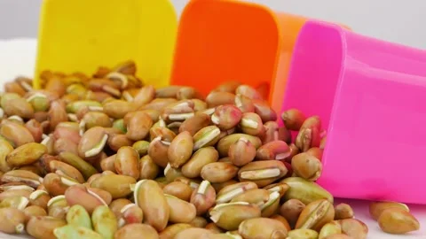 Close view of bean seeds placed near plastic glasses Video stock 159639382