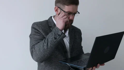 Close up view of bearded middle aged man in glasses using laptop computer Stock Footage 180397500
