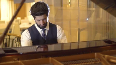 Close up view of bearded pianist playing the fortepiano enjoying the virtuoso Stock Footage 105075255