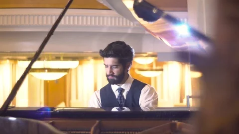 Close up view of bearded pianist playing the fortepiano enjoying the virtuoso Stock Footage 105075323