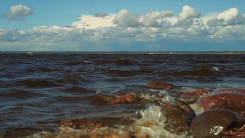 Close up view of beating waves at the beach. Rocky shore of finland gulf Stock Footage 240831788