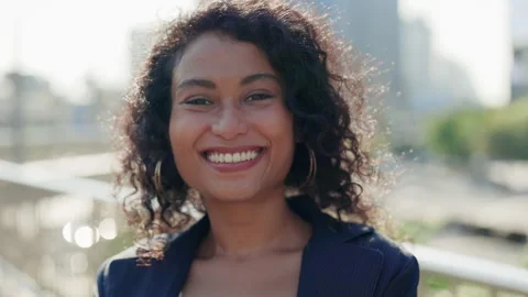 Close-Up View of a Beautiful, Curly-Haired Girl Posing for the Camera with a Stock Footage 303841277
