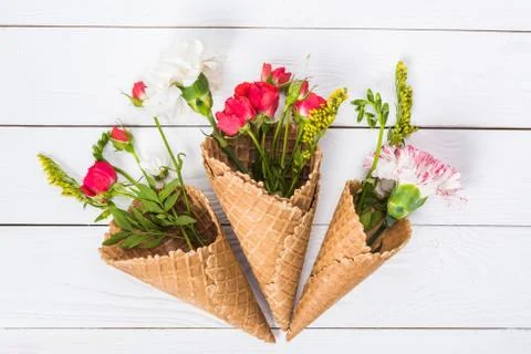 Close-up view of beautiful floral composition with flowers and waffle cones o Stock Photos