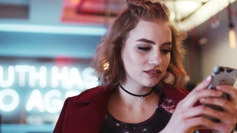 Close up view of a beautiful girl using her phone for online communication Stock Footage 74004850