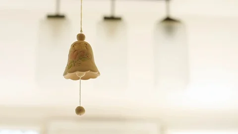 Close up view of beautiful handmade ceramic bell moving in the air with amazing 스톡 동영상 89772882