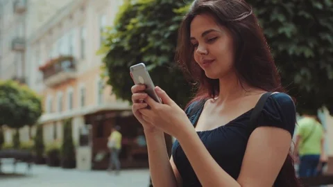 Close up view of a beautiful long-haired woman using her cell-phone for texting Stock Footage 76922972