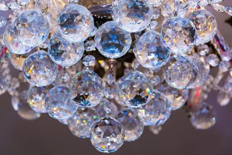 Close up view of beautiful round shape crystal chandelier hanging from ceilin Stock Photos