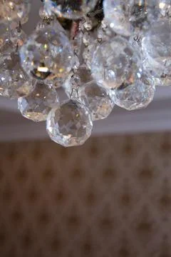 Close up view of beautiful round shape crystal chandelier hanging from ceilin Stock Photos