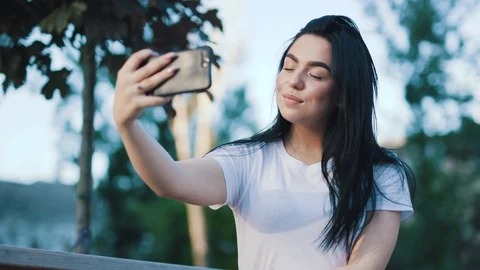 Close up view of beautiful stylish young brunette woman taking selfie via modern Stock Footage 111219517