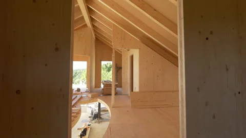 CLOSE UP: View of beautiful unfinished interior of a prefabricated lumber house. Video stock 152002645