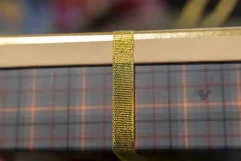 A close-up view of a beautifully wrapped gift box featuring a checkered pattern, Stock Photos