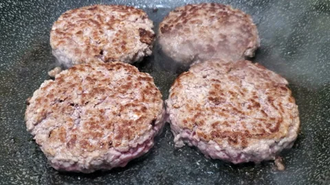 Close up view of beef hamburger cooking on hot surface,tasty american food 4k Stock Footage 142718029