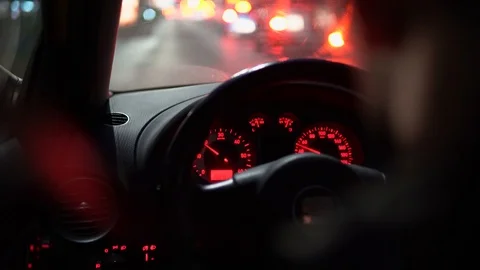 Close-up view behind a driver in a car, the car moves at a night road 動画素材 126995164