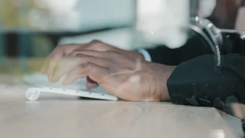 Close up view behind glass hands work with computer keyboard african man Stock Footage 219356302