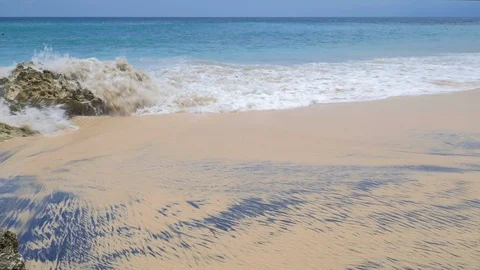 Close up view of big waves on a tropical beach with yellow and black sand Stock Footage 115018050