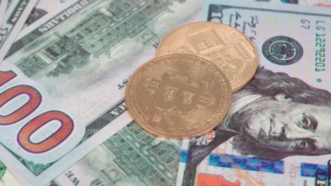 Close-up view of bitcoin coins and dollar bills. The virtual currency of th.. Stock Footage 289493010