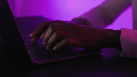 Close Up View Of Black Arms Texting on Laptop. Close up view of Hands in Violet Stock Footage 231436114