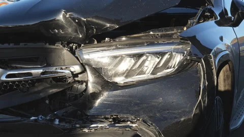Close-up view of a black car with severe front-end collision damage. Stock Footage 297122905