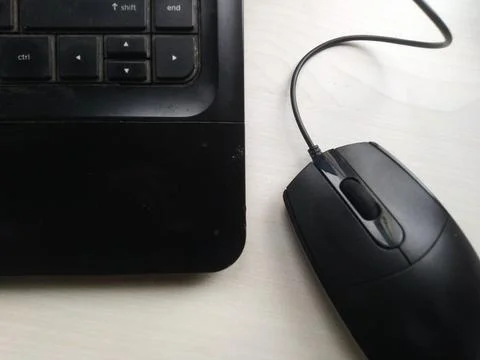 Close up view of black computer mouse and keyboard on a white tabletop, perfe Stock Photos