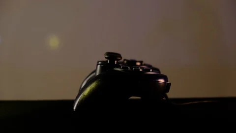 Close-up view black controller on table to play video games on game console. Stock Footage 130055489