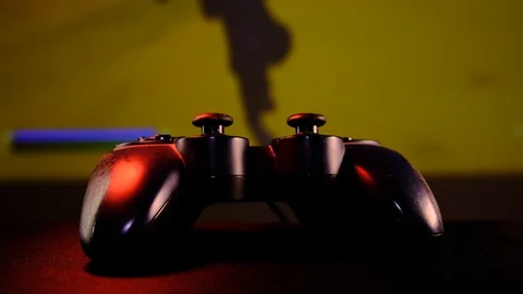 Close-up view black controller on table to play video games on game console. Vidéo 130055526