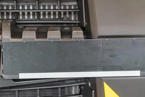 Close-up view of a black mechanical structure with a white stripe, possibly m 스톡 사진