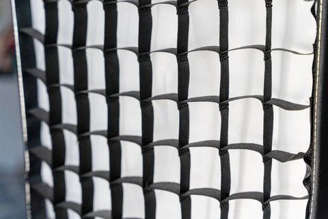 Close view of a black mesh net with a grid pattern in a bright background Stock Photos