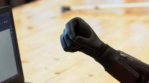 Close view of a black modern bionic hand flexing and extending fingers. Stock Footage 168040937