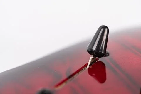 Close-up view of black pick pressing strings on modern heavy rock electric .. Stock Photos