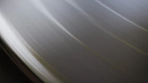 Close-up view of a black vinyl record spinning on a turntable. Stock Footage 320027089