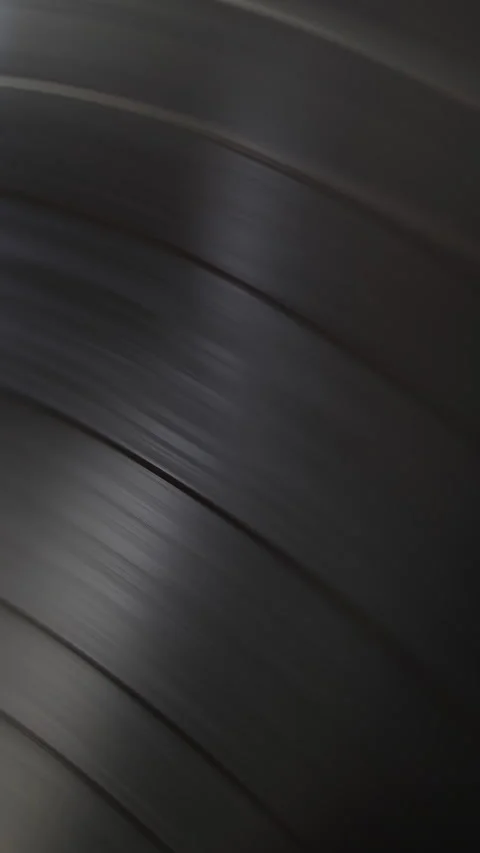 Close-up view of a black vinyl record spinning on a turntable.  Stock Footage 320027214