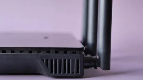 Close up view of black wifi router with three antennas, network device for .. Stock Footage 332625012